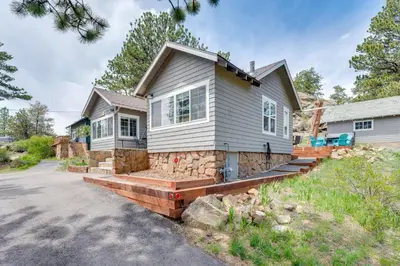 a house with a stone staircase in front of a driveway at Steps to Estes Lake Mtn-View Hideaway with Hot Tub! in Estes Park