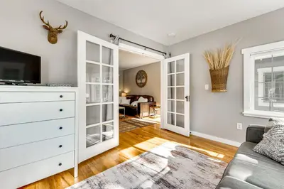 a living room with a couch and a tv at Steps to Estes Lake Mtn-View Hideaway with Hot Tub! in Estes Park