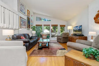 a living room with a couch and a table at Mid-Century Mod Retreat with Lakefront Trails, Quiet in Fort Collins