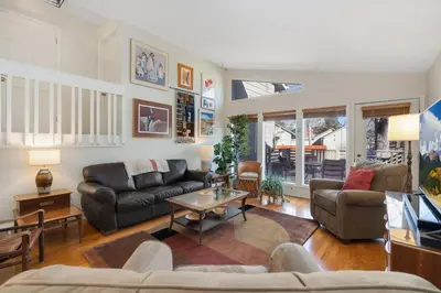 a living room with a couch and a table at Mid-Century Mod Retreat with Lakefront Trails, Quiet in Fort Collins