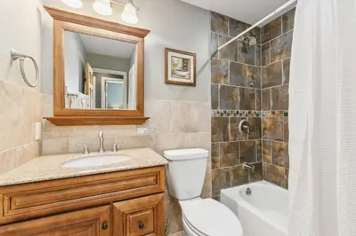 a bathroom with a toilet and a sink and a shower at The Rustic Retreat, Pet Friendly with Fenced Yard in Fort Collins