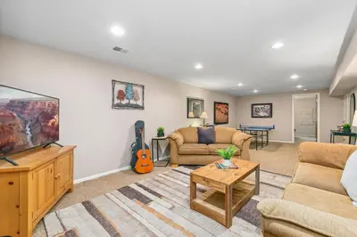 a living room with a couch and a tv at The Rustic Retreat, Pet Friendly with Fenced Yard in Fort Collins