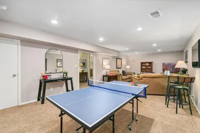 a living room with a ping pong table at The Rustic Retreat, Pet Friendly with Fenced Yard in Fort Collins