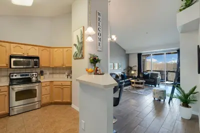 an open kitchen and living room in a apartment at Timberline Retreat - King Bed, Fireplace & Pool! in Fort Collins