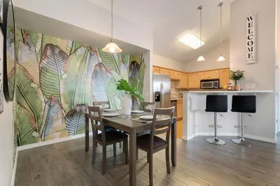 a kitchen and dining room with a table and chairs at Timberline Retreat - King Bed, Fireplace & Pool! in Fort Collins