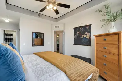 a bedroom with a bed and a ceiling fan at Timberline Retreat - King Bed, Fireplace & Pool! in Fort Collins