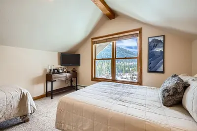 a bedroom with a large bed and a window at 5959 Hidden River Lodge condo in Keystone