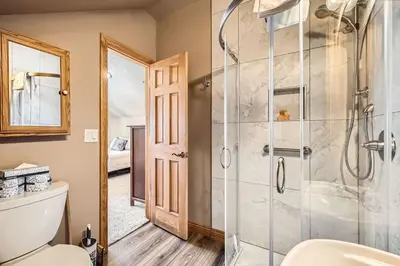 a bathroom with a shower and a toilet at 5959 Hidden River Lodge condo in Keystone