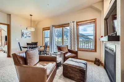 a living room with a couch and chairs and a fireplace at 5959 Hidden River Lodge condo in Keystone