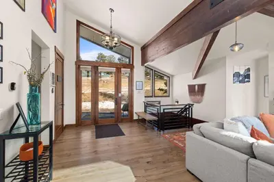 a living room with a couch and a table at Ridge View Retreat - Panoramic Views and Hot Tub in Nederland