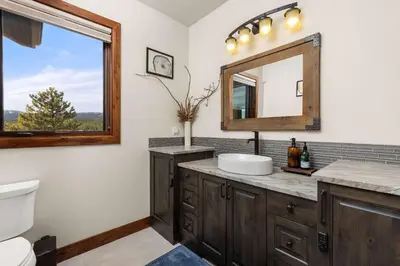 a bathroom with a sink and a mirror at Ridge View Retreat - Panoramic Views and Hot Tub in Nederland