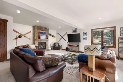 a living room with leather furniture and a tv at Ridge View Retreat - Panoramic Views and Hot Tub in Nederland