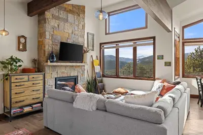 a living room with a couch and a fireplace at Ridge View Retreat - Panoramic Views and Hot Tub in Nederland