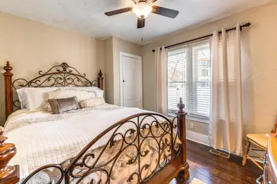 a bedroom with a bed and a ceiling fan at Historical Dtwn Loveland Home with Wraparound Porch! in Loveland
