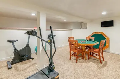 a room with a ping pong table and a gym at Historical Dtwn Loveland Home with Wraparound Porch! in Loveland