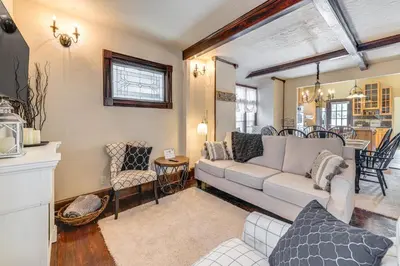 a living room with a couch and a table at Historical Dtwn Loveland Home with Wraparound Porch! in Loveland