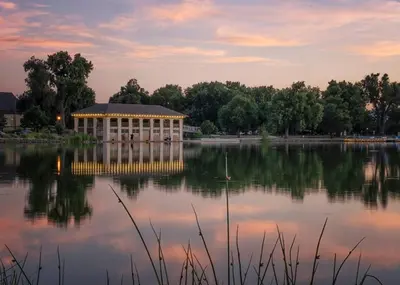 a large building sitting on top of a lake at 1920s Inspired Stay-coffee Bar- Cozy-local in Denver