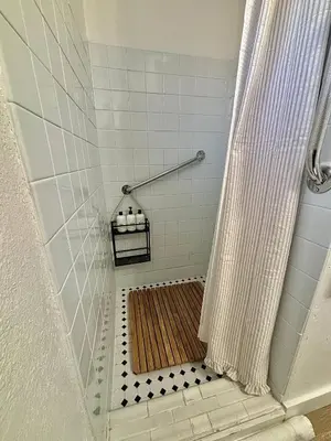 a shower with a shower curtain in a bathroom at 1920s Inspired Stay-coffee Bar- Cozy-local in Denver