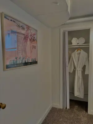 a room with a closet with a robe and towels at 1920s Inspired Stay-coffee Bar- Cozy-local in Denver