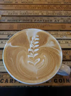 a cup of coffee sitting on top of a table at 1920s Inspired Stay-coffee Bar- Cozy-local in Denver