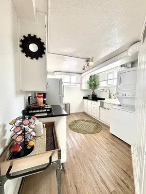 a kitchen with white appliances and a wooden floor at 1920s Inspired Stay-coffee Bar- Cozy-local in Denver