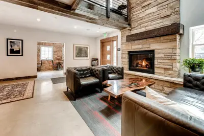 a living room with leather furniture and a fireplace at A-Lodge Boulder in Boulder