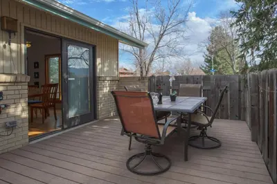 a patio with a table and chairs on a deck at 5 bedroom, 7 beds, 3 bath - Sleeps 12, Great for Families in Boulder