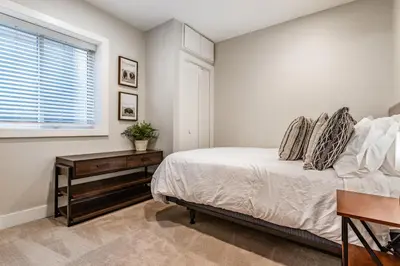 a bedroom with a bed and a window at Luxury 5-Bedroom Home in LoHi in Denver