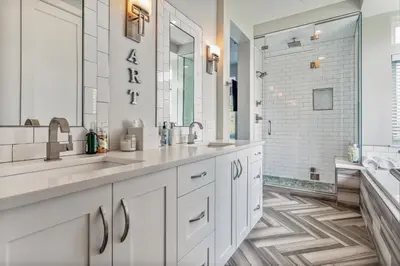 a white bathroom with two sinks and a shower at Luxury 5-Bedroom Home in LoHi in Denver