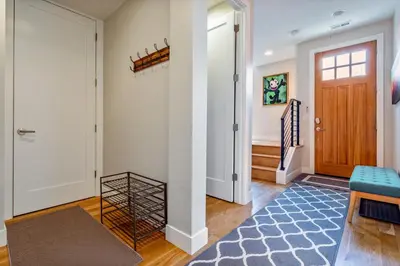 a hallway with a door and a blue rug at Luxury 5-Bedroom Home in LoHi in Denver