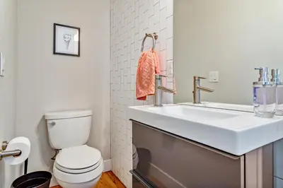 a bathroom with a white sink and a toilet at Luxury 5-Bedroom Home in LoHi in Denver