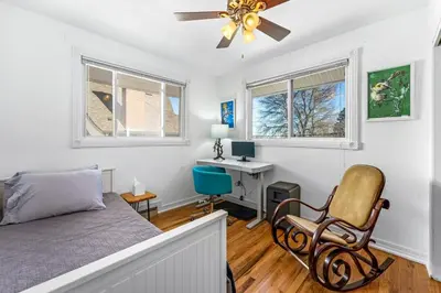 a bedroom with a bed and a desk and a chair at Epic Mntn views private hot tub and 420 friendly in Denver