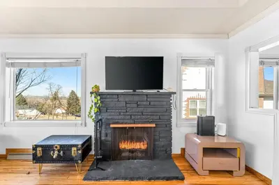 a living room with a fireplace with a flat screen tv at Epic Mntn views private hot tub and 420 friendly in Denver