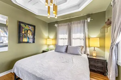 a bedroom with a bed and two lamps and a window at Epic Mntn views private hot tub and 420 friendly in Denver