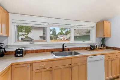 a kitchen with a sink and two windows at Peterson Retreat - Hot Tub, Bikes, Old Town in Fort Collins
