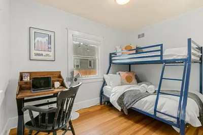 a bedroom with a blue bunk bed and a desk at Peterson Retreat - Hot Tub, Bikes, Old Town in Fort Collins