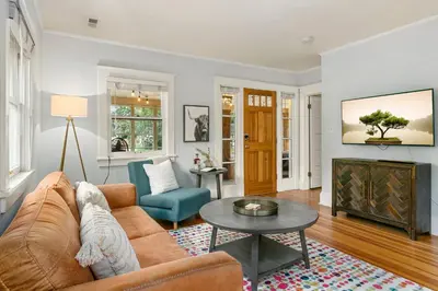 a living room with a couch and a tv at Peterson Retreat - Hot Tub, Bikes, Old Town in Fort Collins