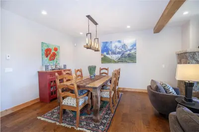 a dining room with a table and chairs and a couch at Private Neighborhood Lake, Upscale Quality, 2 Living Rooms, Close to Raven Golf Club in Silverthorne