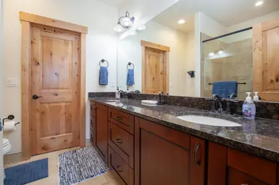 a bathroom with a sink and a large mirror at Private Neighborhood Lake, Upscale Quality, 2 Living Rooms, Close to Raven Golf Club in Silverthorne