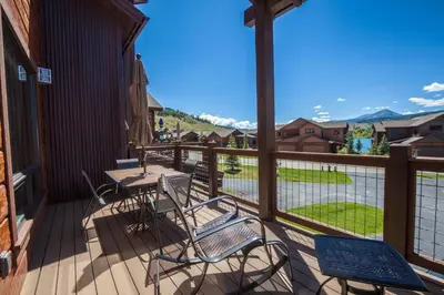 a balcony with a table and chairs and a view of the mountains at Private Neighborhood Lake, Upscale Quality, 2 Living Rooms, Close to Raven Golf Club in Silverthorne