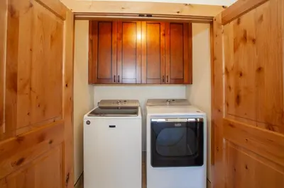 a small kitchen with a stove and a dryer at Private Neighborhood Lake, Upscale Quality, 2 Living Rooms, Close to Raven Golf Club in Silverthorne