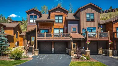a large house with a mountain at Private Neighborhood Lake, Upscale Quality, 2 Living Rooms, Close to Raven Golf Club in Silverthorne