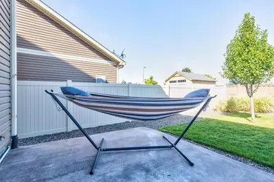 a hammock in a yard in front of a house at 5400sqft 6BR 5BA Theater, Office, Game Room in DEN