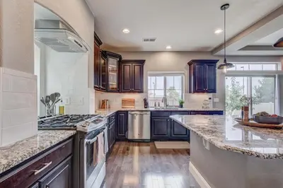 a large kitchen with wooden cabinets and a counter top at 5400sqft 6BR 5BA Theater, Office, Game Room in DEN
