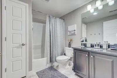 a bathroom with a toilet and a sink and a shower at 5400sqft 6BR 5BA Theater, Office, Game Room in DEN