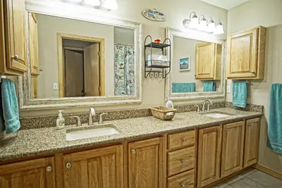 a bathroom with two sinks and a large mirror at Hot Tub, Blue River in Backyard, Close to 5 Ski Resorts, On Free Bus Route, New Listing in Silverthorne