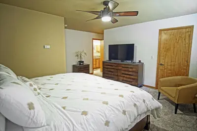 a bedroom with a bed and a flat screen tv at Hot Tub, Blue River in Backyard, Close to 5 Ski Resorts, On Free Bus Route, New Listing in Silverthorne