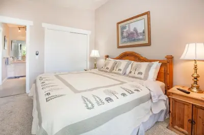 a bedroom with a bed with a white comforter at Pool and Hot Tubs, On Lake Dillon, Beautiful Views in Dillon