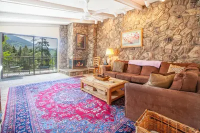 a living room with a couch and a table and a fireplace at Pool and Hot Tubs, On Lake Dillon, Beautiful Views in Dillon