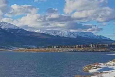a large body of water with snowy mountains in the background at Pool and Hot Tubs, On Lake Dillon, Beautiful Views in Dillon